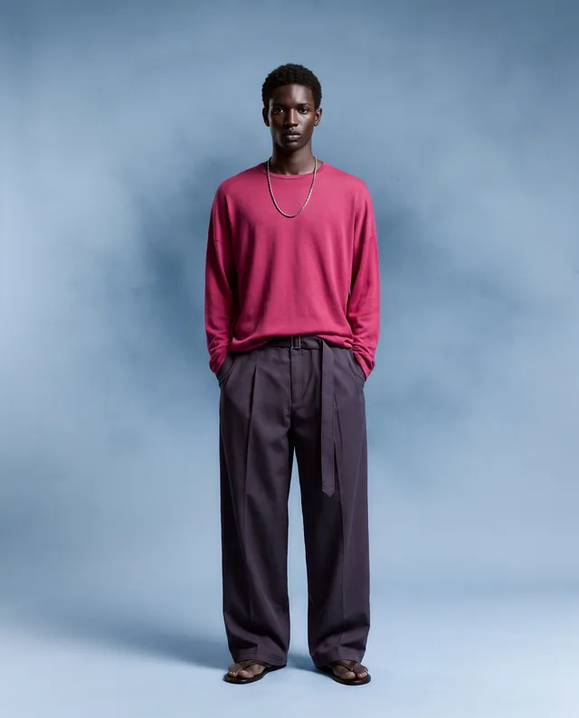 Cobalt Haze — Cool blue textured studio with vivid fuchsia knitwear and elongated charcoal proportions.